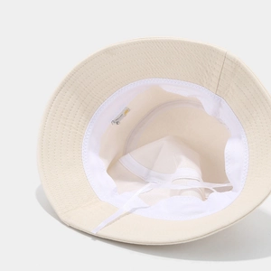 Detail view of cotton bucket hat interior showing adjustable wind rope and sweatband