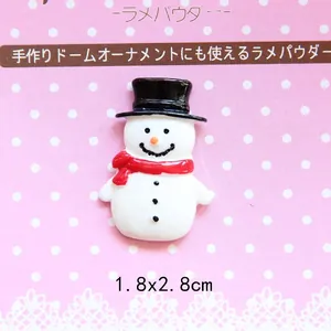 Detailed view of snowman resin charm with black hat and red scarf for DIY crafts