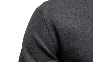 Close-up of shoulder seam stitching on a dark grey V-neck knit sweater for men