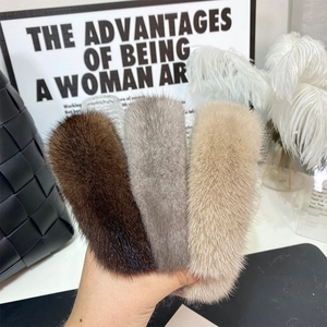 Detailed texture of mink fur headbands in dark brown, grey, and beige neutral tones