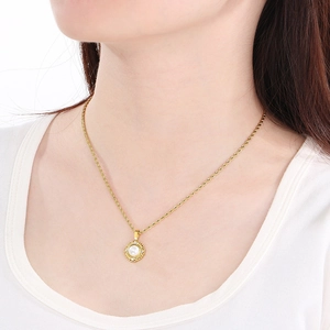 Gold stainless steel pearl necklace with diamond circle pendant on model neck