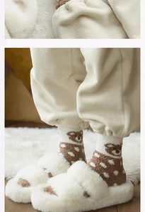 Close-up of cozy coral fleece socks with bear pattern and matching plush home slippers