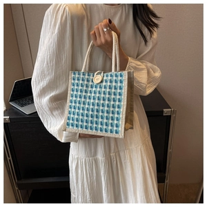 Detail of blue and white checkered jute tote bag with button closure and rope handle
