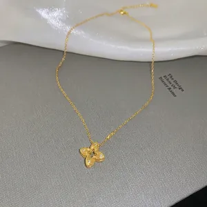 Gold flower necklace with zircons on elegant white silk and grey textured backdrop