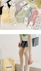 Detail of pastel cotton socks with ribbed cuffs shown in various macaron colors