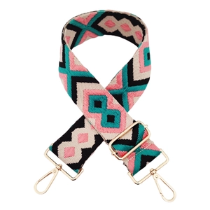 Close-up of diamond pattern woven shoulder strap with gold metal buckles and adjusters