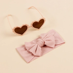 Pink heart-shaped sunglasses with matching ribbed knit bow headband for baby girls