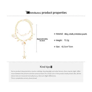 Detail of layered gold necklace with faux pearls and sea shell pendants for beach wear
