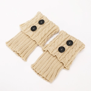 Close-up of beige cable knit leg warmers with ribbed texture and black button accents