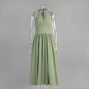 Detail of sage green cotton maxi dress with deep V-neckline and elegant pleated texture