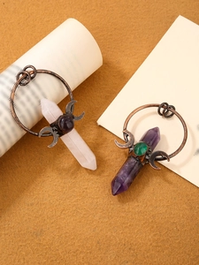 Detail of vintage bronze pendants featuring amethyst and rose quartz hexagonal crystals