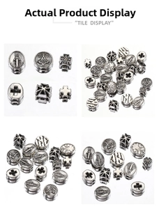 Detailed macro of vintage silver religious beads featuring crosses and saint relief carvings