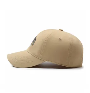 Side view of khaki cotton baseball cap featuring embroidered logo and reinforced brim