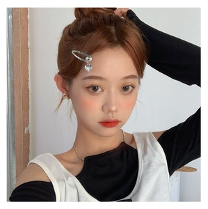 Detail of silver heart pendant hair clip with rhinestone on a fashion model