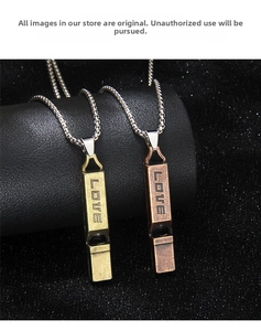 Detail of vintage square whistle pendant with LOVE engraving on a beaded necklace chain