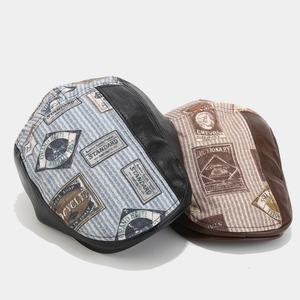 Detail view of vintage flat caps featuring PU leather patchwork and retro stamp patterns
