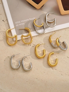 Modern two-tone C-shape hoop earrings set in gold and silver finish for beach styling