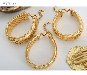 Detail of three gold twisted metal bracelets with lobster clasp and K18 engraving