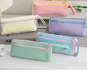 Detailed set of five canvas pencil cases in pastel colors with large zipper rings