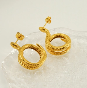 Detailed view of snake-shaped gold earrings with intricate scale texture and design