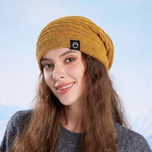 Winter knitted beanie in mustard yellow with fleece lining and mountains logo patch