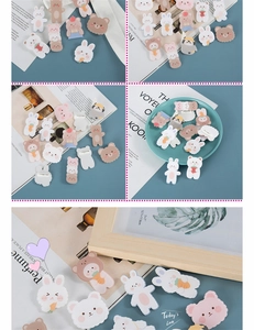 Detail view of cute acrylic animal pins featuring bears and rabbits on various backgrounds