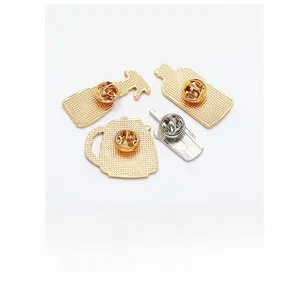 Detail of enamel pin backs featuring golden and silver plating with butterfly clutches