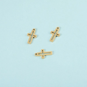 Detailed close-up of three gold hollow cross charms for DIY jewelry making and crafts