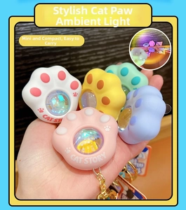 Detailed view of colorful cat paw keychain lights with glittery glowing spheres