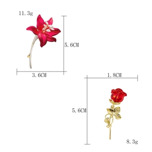 Detailed size and weight specs for red lily and rose brooches with crystal accents