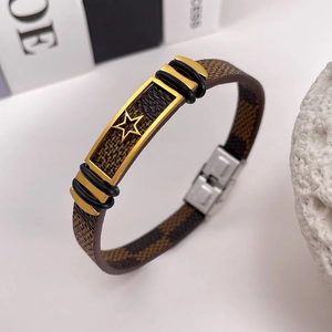 Macro view of brown checkered leather strap and golden star metal buckle detail