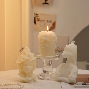 Detail of artistic woman portrait scented candle with creative geometric pillar in cream white