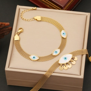 Golden mesh chain necklace and bracelet set with blue evil eye charms and round pendants