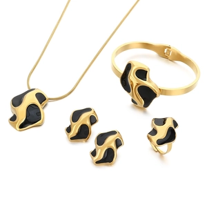 Luxurious black and gold geometric stainless steel jewelry set with pearls on white backdrop
