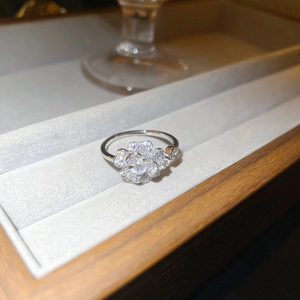 Close-up of elegant flower ring with pavé zircons on gray jewelry velvet display