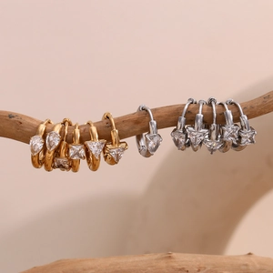 18K gold plated geometric hoop earrings with teardrop and square zircon hanging on wood branch