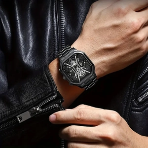 Close-up of a black square dial watch on a male wrist with a leather jacket backdrop