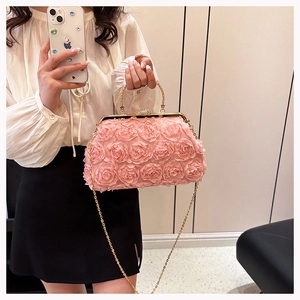 Detailed view of pink 3D rose flower handbag with gold frame and elegant chain strap