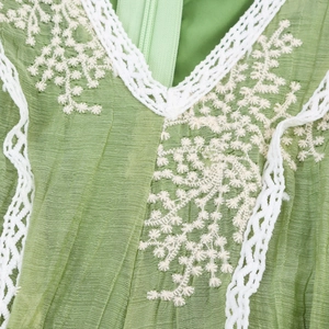 Elegant green French V-neck dress with white lace embroidery and pleated texture details