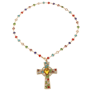 Gold necklace with heart links and colorful zircon cross pendant on a white background