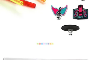 Macro detail of 7mm music themed shoe charms with rock gesture and note wing design