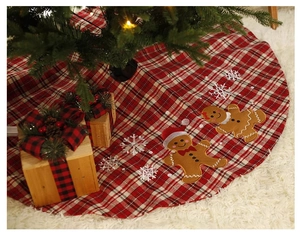 Detailed Christmas tree skirt featuring gingerbread man embroidery and red plaid fabric
