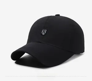 Detail of black baseball cap showing the silver shield R patch and six-panel crown