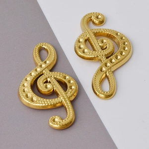 Detail shot of golden treble clef musical note pendants made of 304 stainless steel