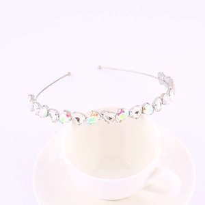 Detail of silver headband with teardrop colorful crystals on a white coffee cup