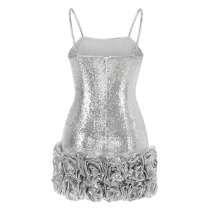 Detail of silver sequin mini dress featuring 3D floral hem and high-shine metallic texture
