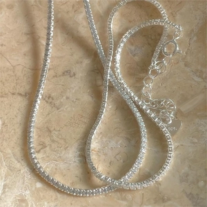 Detail of 925 sterling silver anklet showing the heart charm and spring clasp