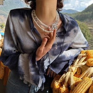 Vintage layered necklace featuring pearl beads, zircon chain, and lion head pendant