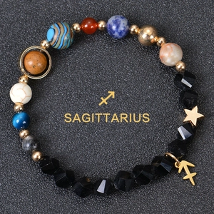 Detailed view of Sagittarius beaded bracelet with faceted black stone and zodiac charm