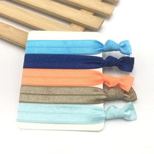 Five colorful knotted elastic hair ties in blue and orange on white card display